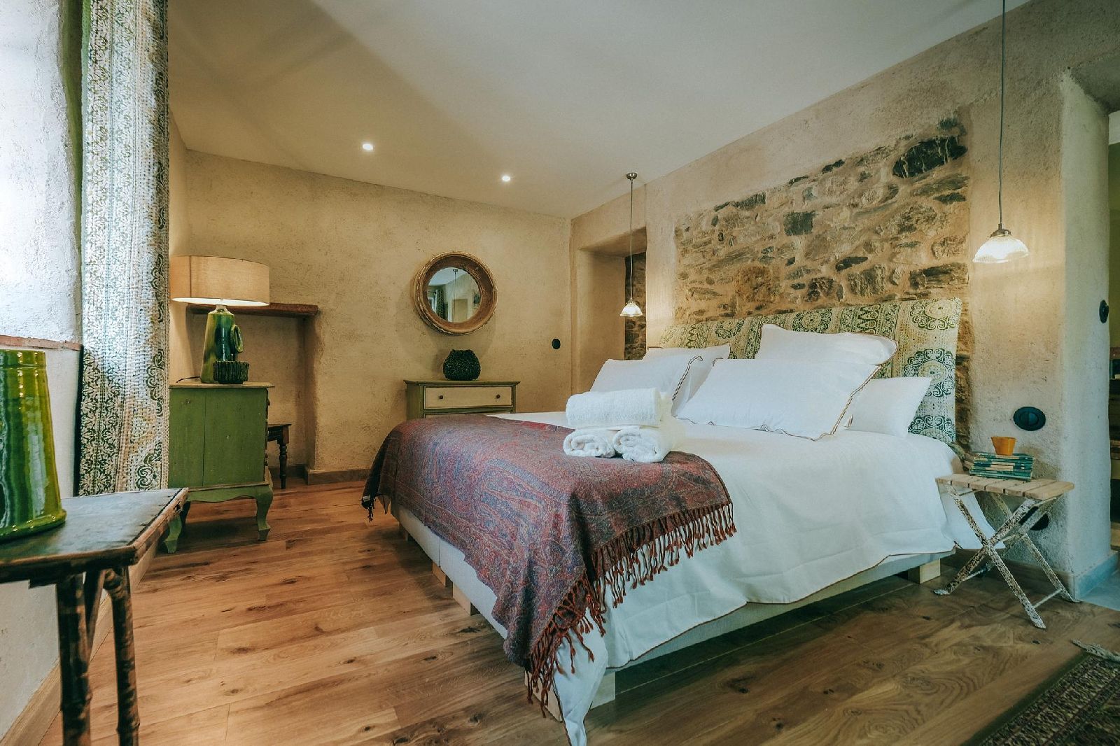 Double bedroom with decorative headboard at Castelnou in South West France