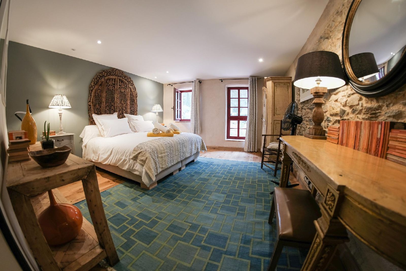 Double bedroom with blue rug at Castelnou in South West France