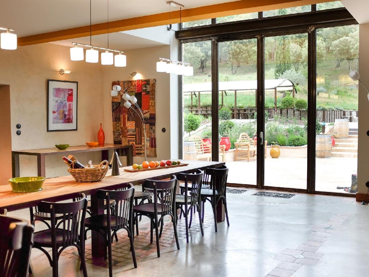 Dining room with floor length windows at Castelnou in South West France