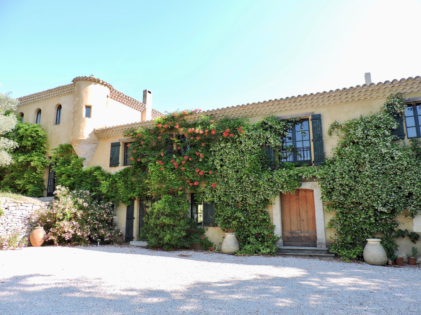 Front of villa with climbing plants, flowers and driveway at Domaine de Corbieres in South West France