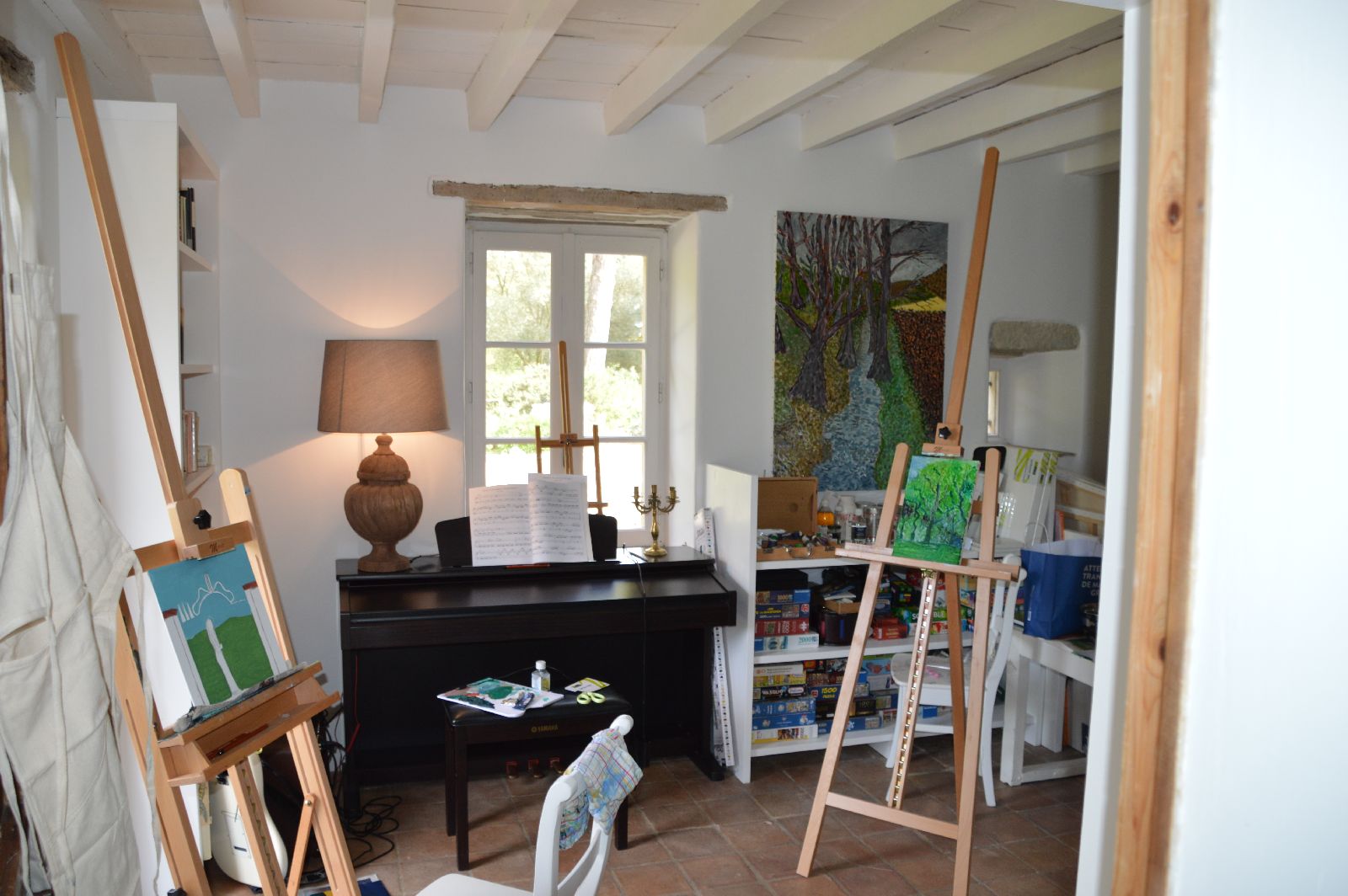 Art room with piano and artwork at Domaine de la Hille in France