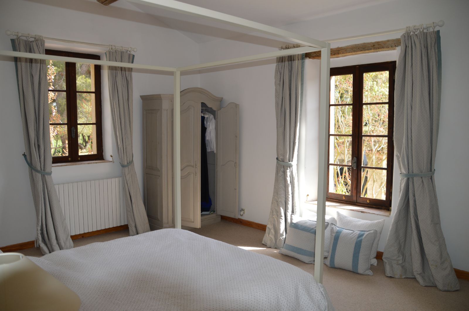 Double bedroom with large windows at Domaine de la Hille in France