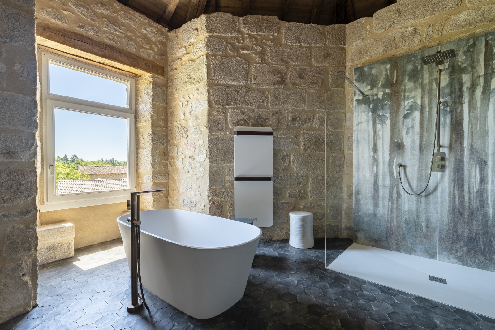 Stone bathroom with free standing bathtub at Le Clos Colombier in France