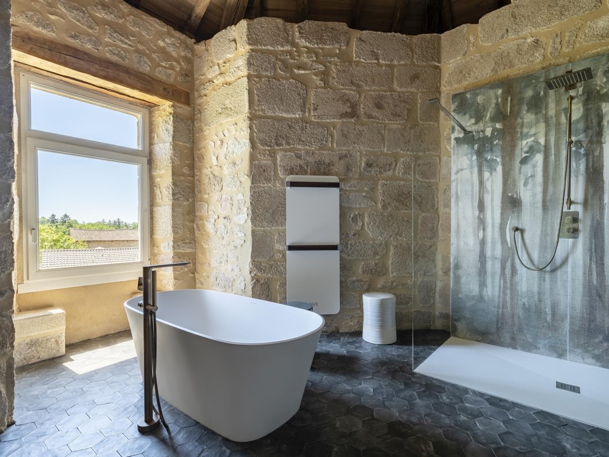 Stone bathroom with free standing bathtub at Le Clos Colombier in France