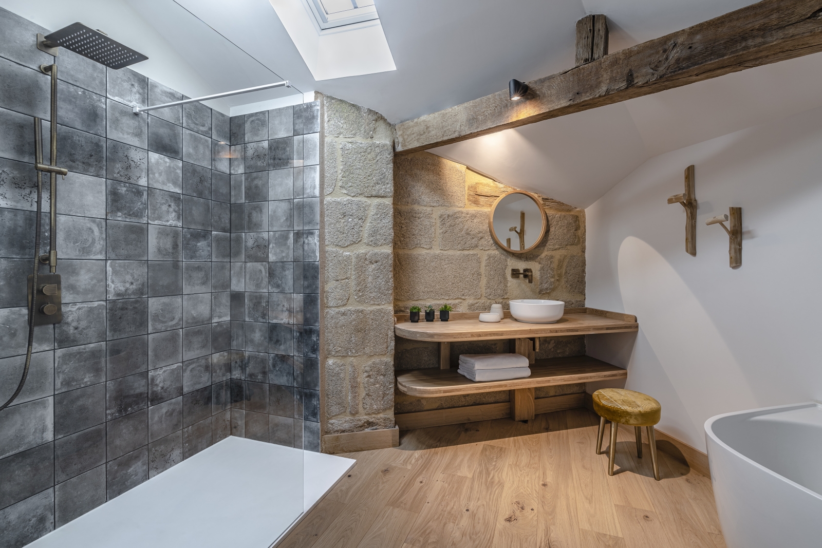 Grey tiled bathroom with walk in rain shower at Le Clos Colombier in France