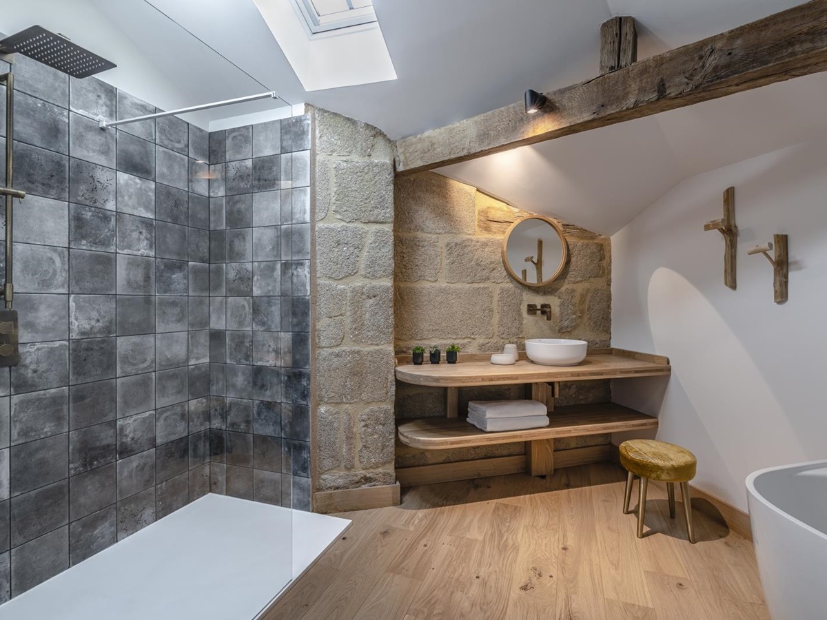 Grey tiled bathroom with walk in rain shower at Le Clos Colombier in France