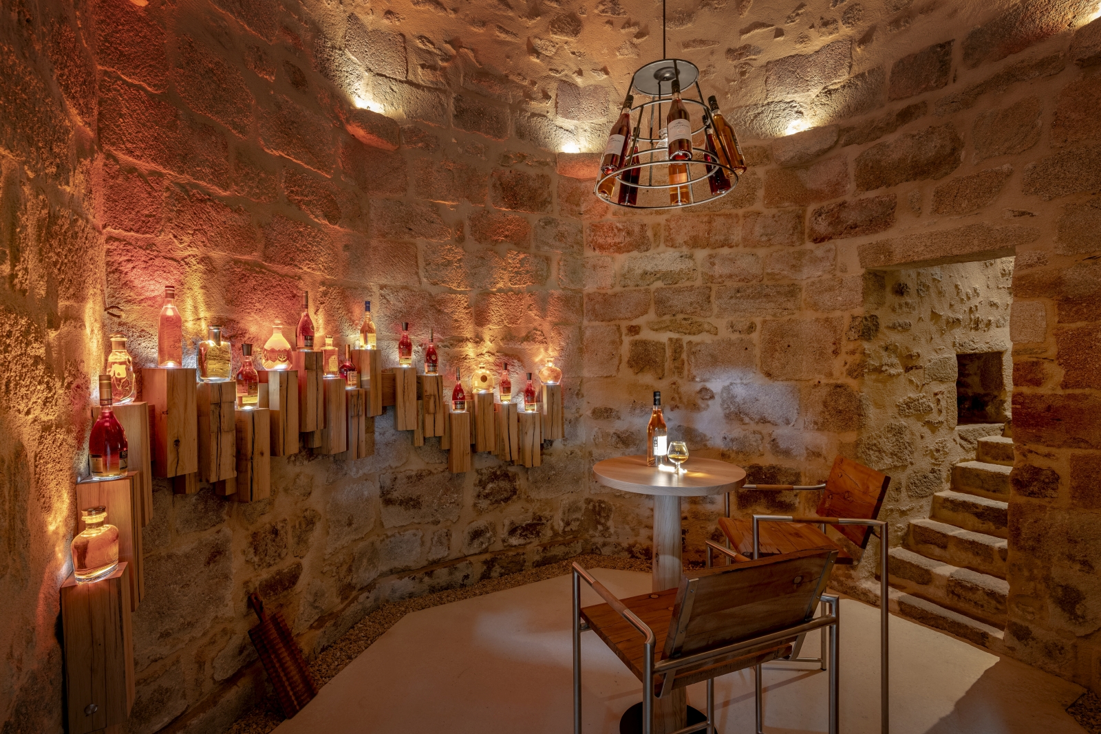 Cellar with warm lighting and seating at Le Clos Colombier in France