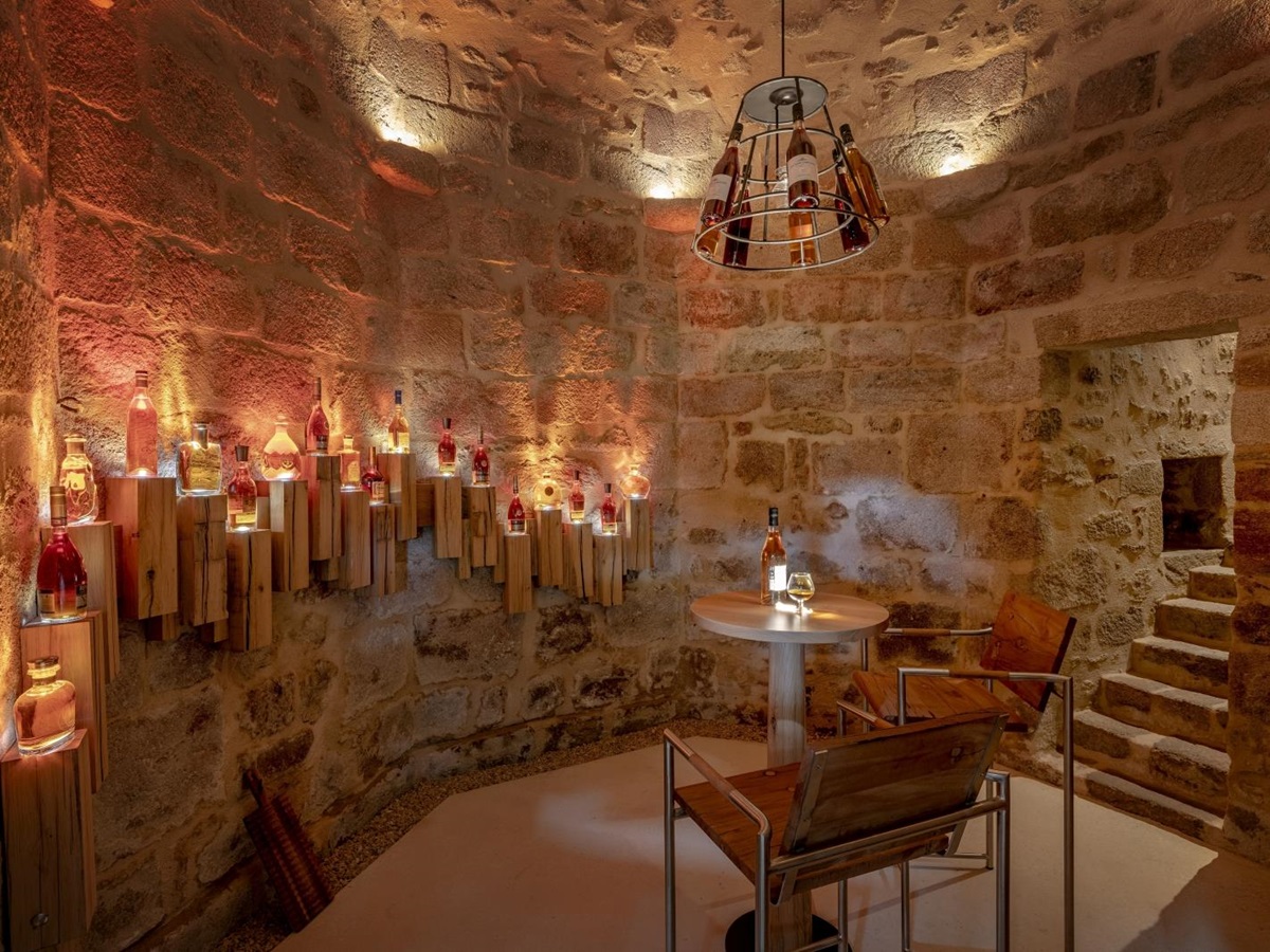 Cellar with warm lighting and seating at Le Clos Colombier in France
