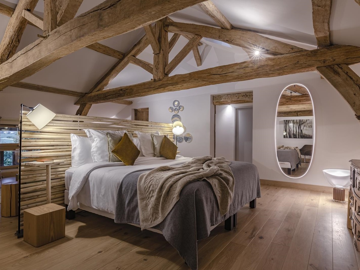 Double bedroom with beamed ceiling at Le Clos Colombier in France
