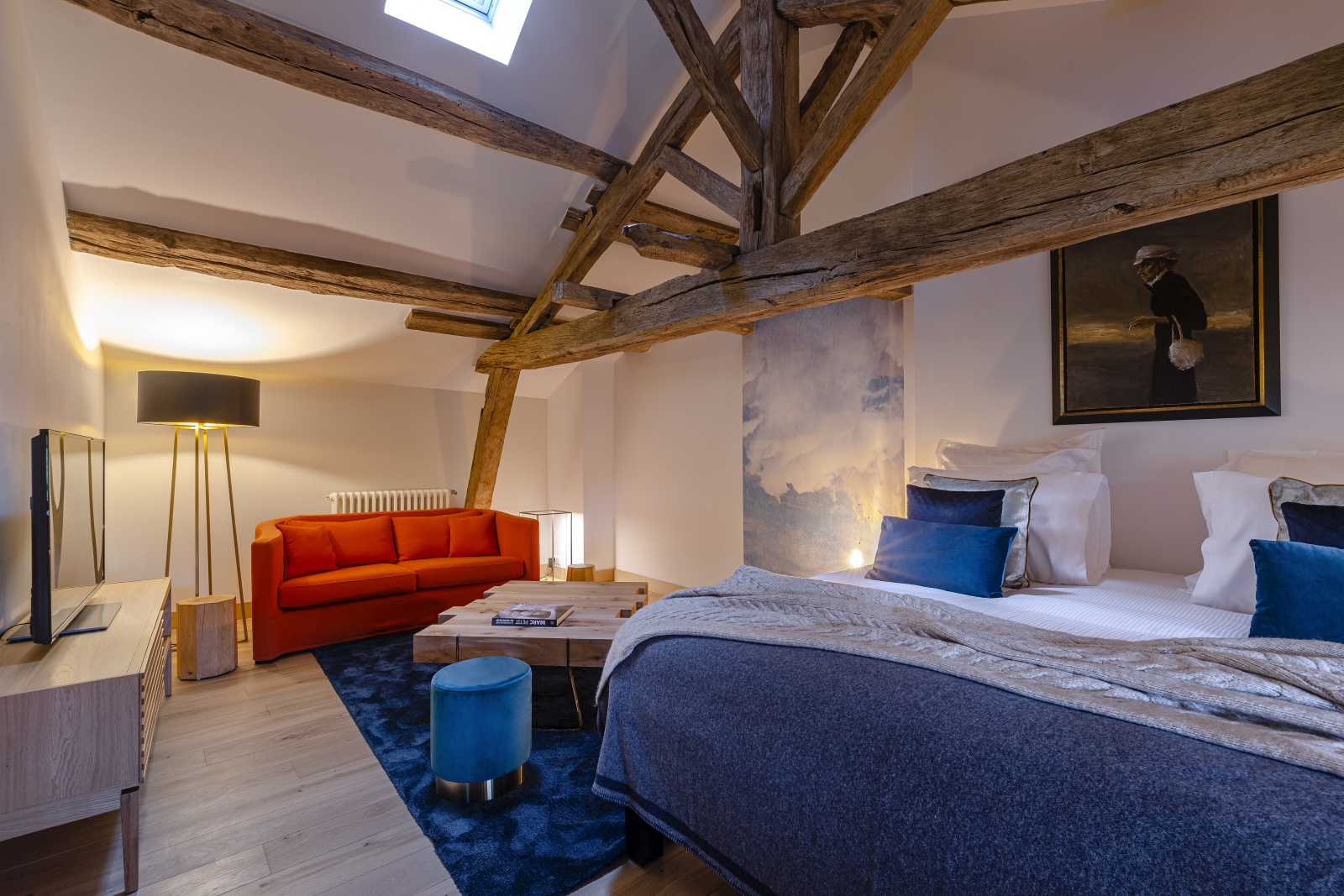 Bedroom with double bed and beamed ceiling at Le Clos Colombier in France