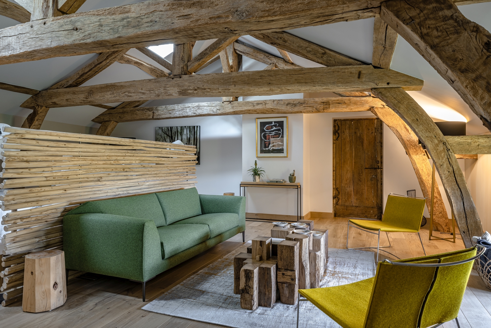 Seating in master bedroom with green sofa at Le Clos Colombier in France