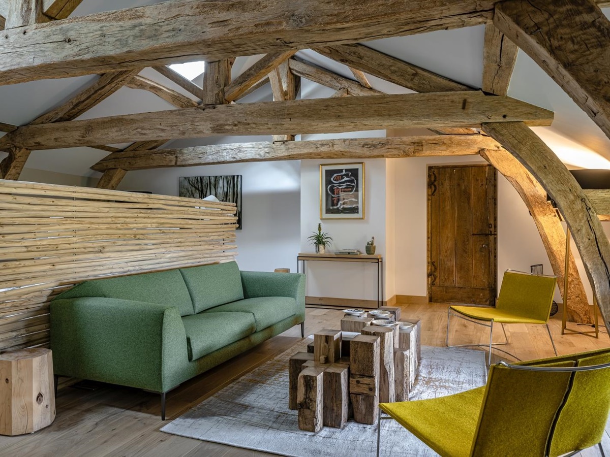 Seating in master bedroom with green sofa at Le Clos Colombier in France