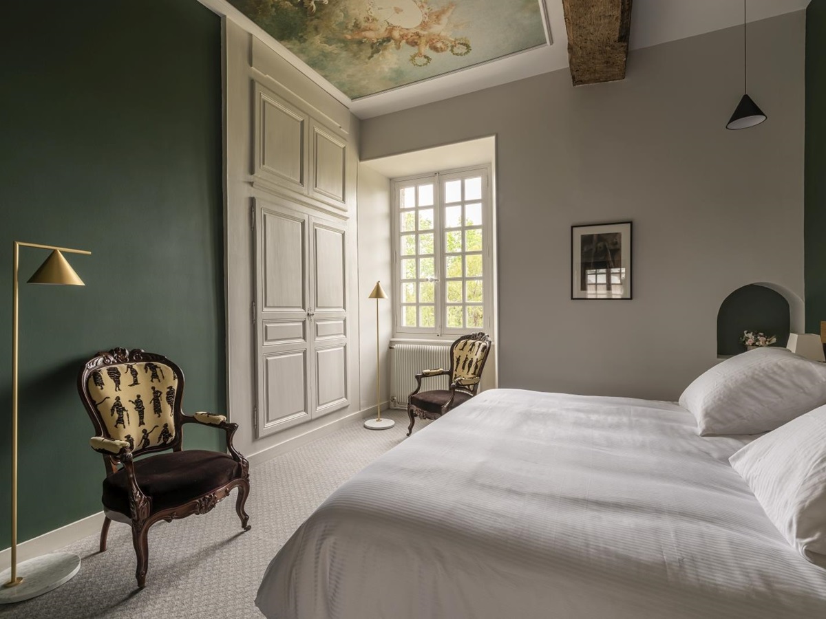 Double bedroom with dark green walls at Le Clos Colombier in France