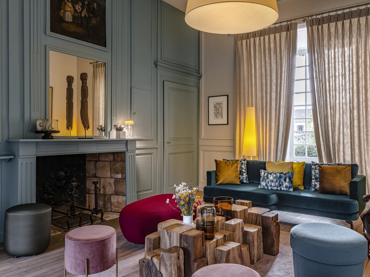 Sitting room with blue sofas and ornate coffee table at Le Clos Colombier in France