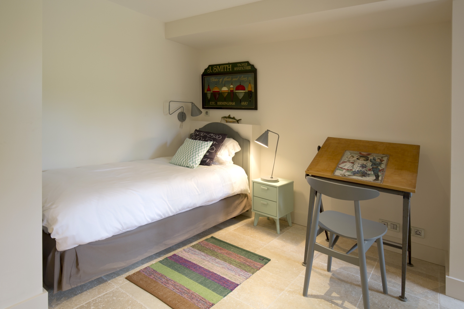 Bedroom with single bed, bedside table, lamps, desk, chair and rug at Villa Carmen in South West France