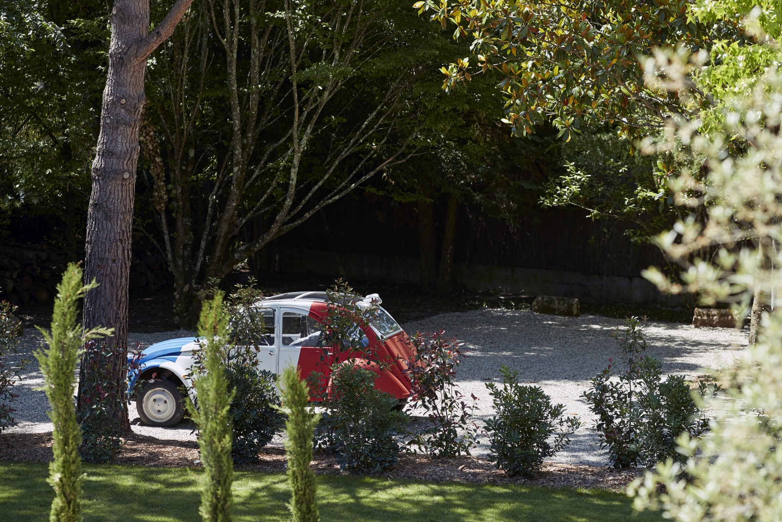 small red and blue car parked at pomiera, france