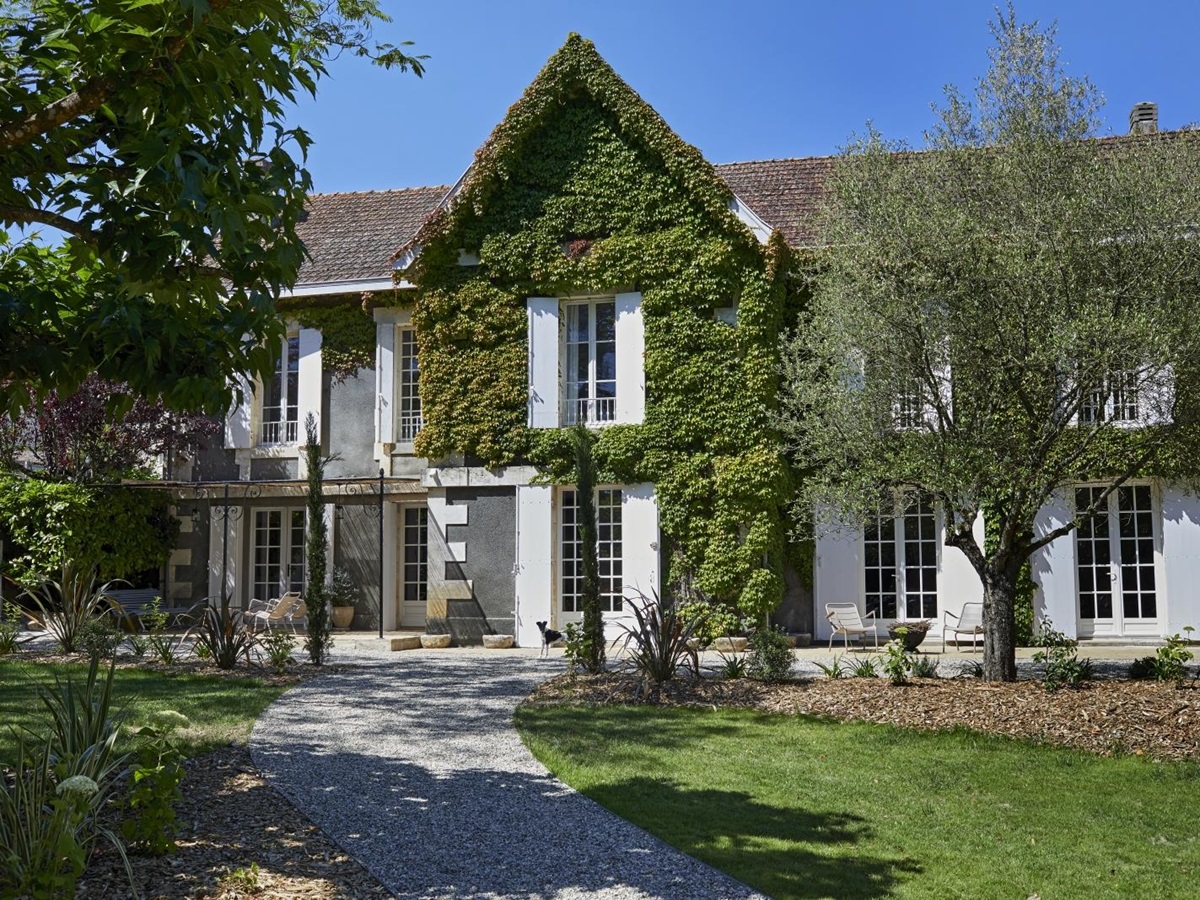 exterior of villa with lush greenery on the facade at pomiera, france