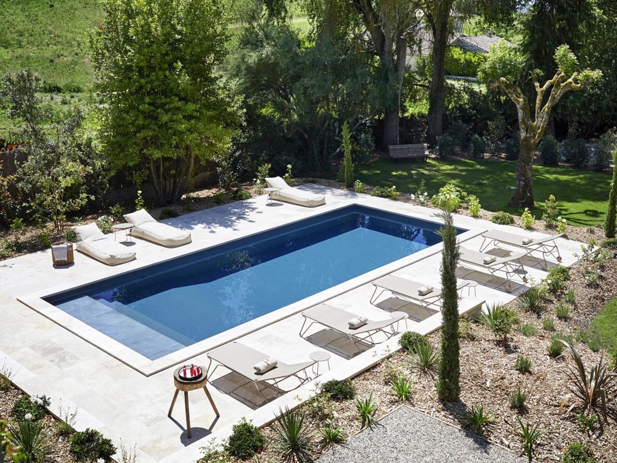 view of pool from villa with loungers at pomiera, france