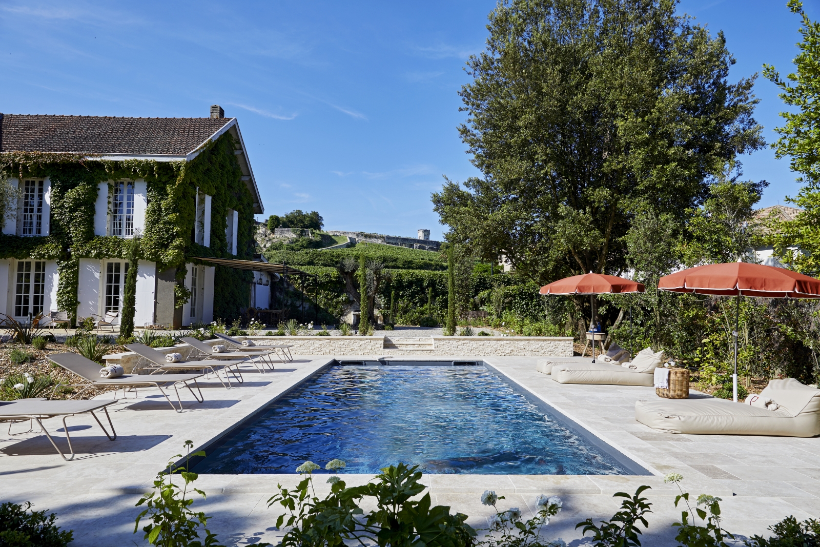 view of the pool lengthways with loungers either side at pomiera, france