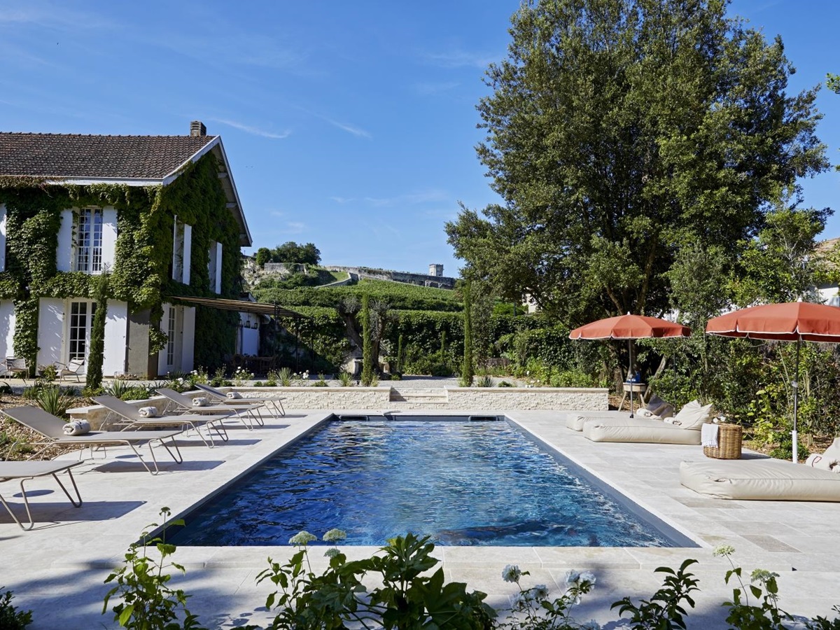 view of the pool lengthways with loungers either side at pomiera, france