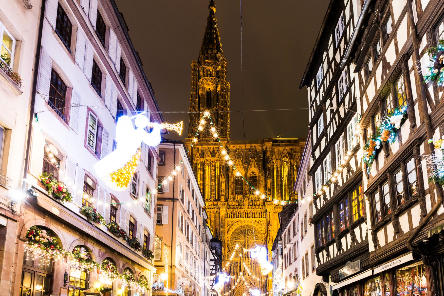 A street in Strasbourg adorned with Christmas lights at night time