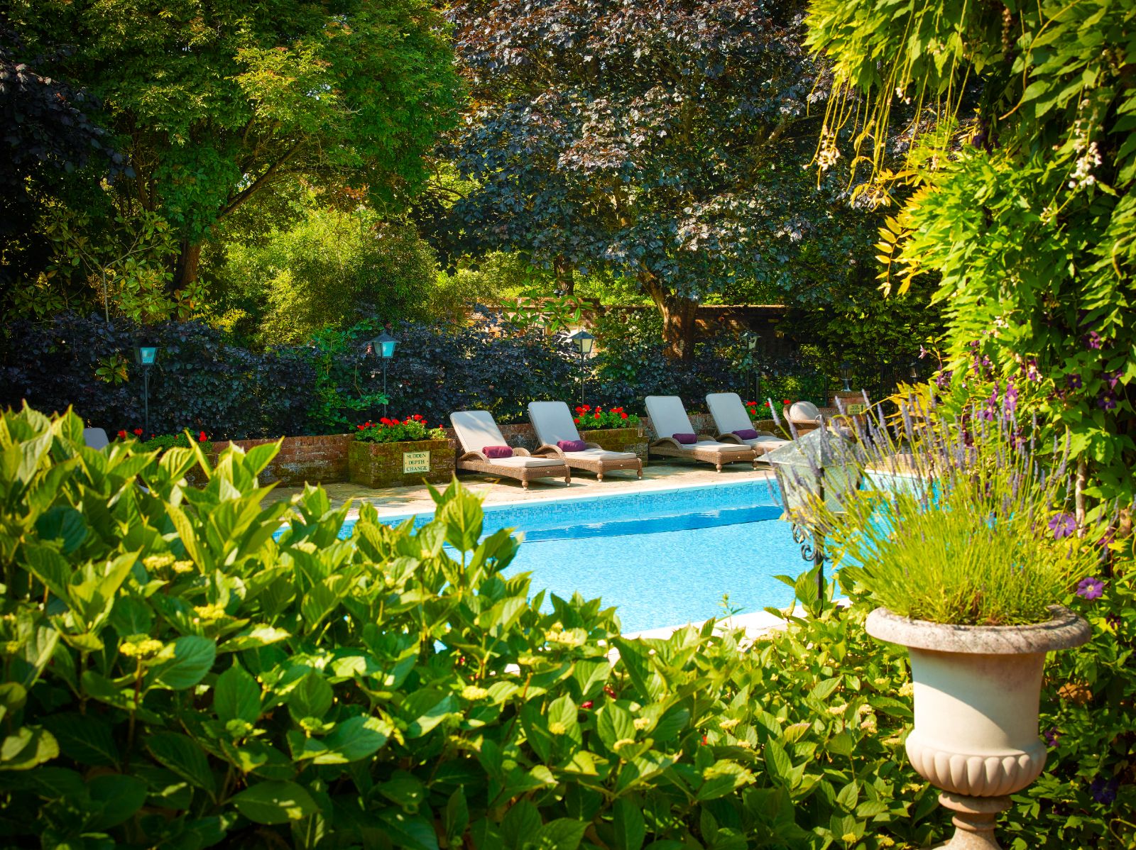 Outdoor swimming pool and gardens at Chewton Glen Resort & Spa Hampshire UK