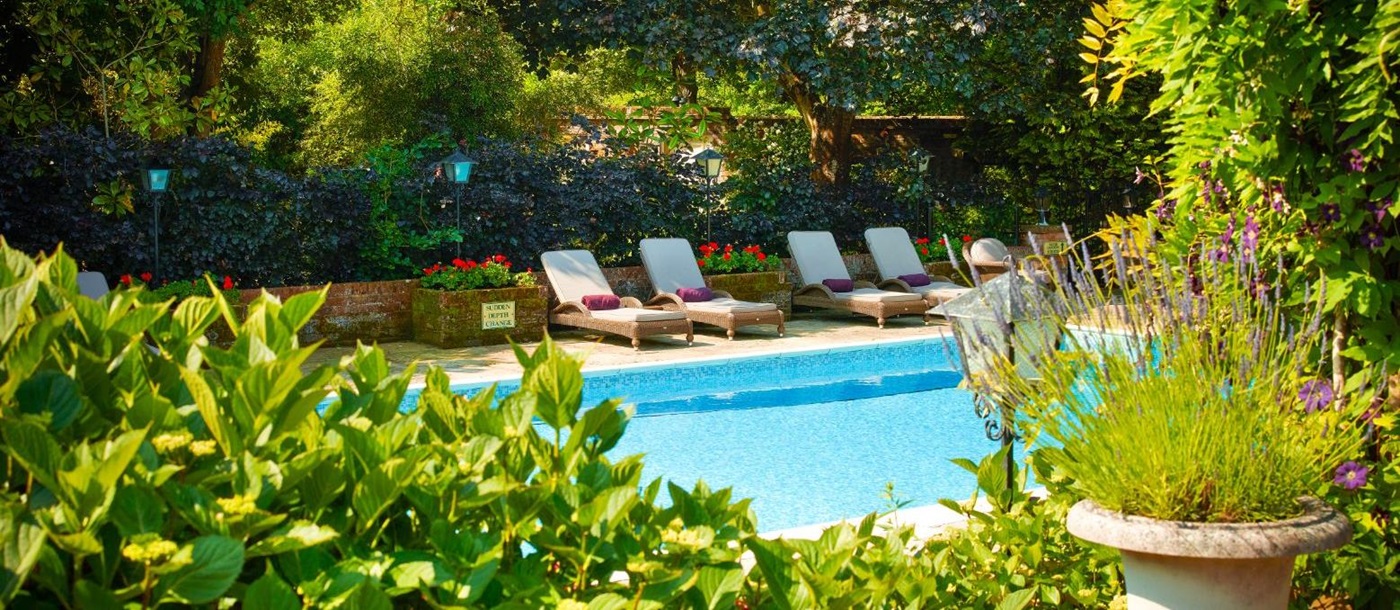 Outdoor swimming pool and gardens at Chewton Glen Resort & Spa Hampshire UK