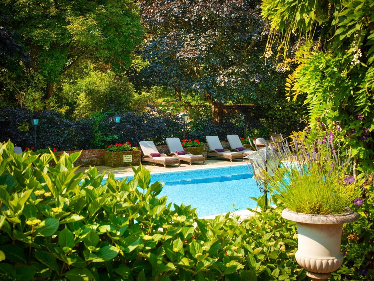 Outdoor swimming pool and gardens at Chewton Glen Resort & Spa Hampshire UK