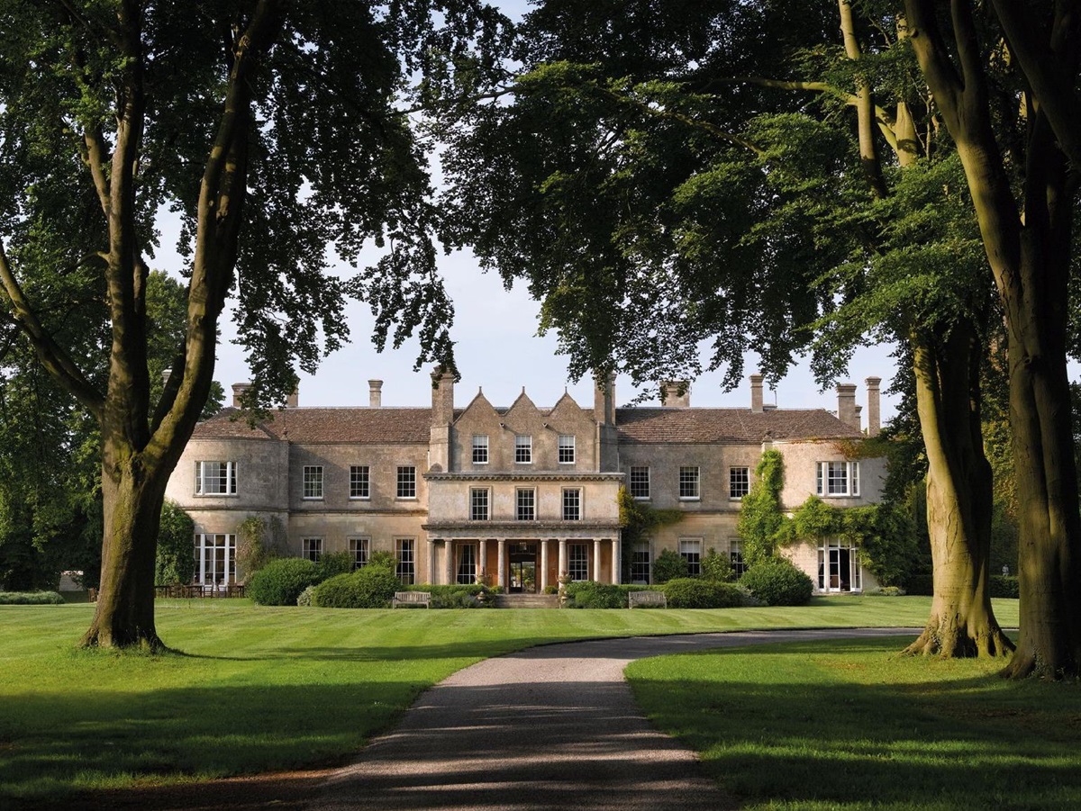 Tree lined avenue leading to Lucknam Park hotel in the Cotswolds England