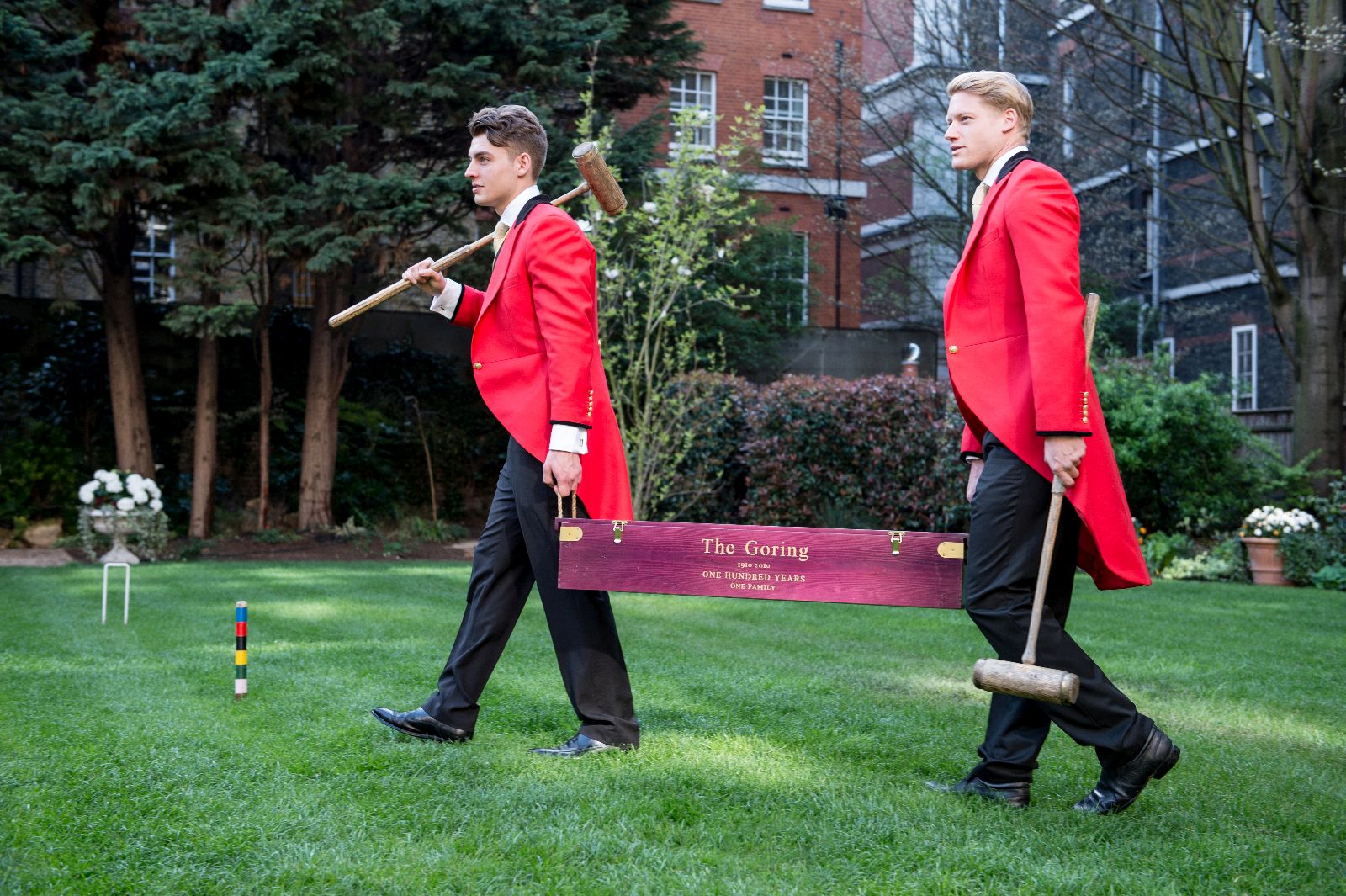 Traditionally dressed footmen setting up croquet on the lawn at The Goring hotel in London