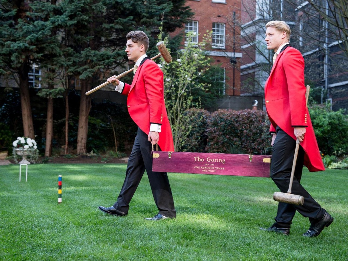 Traditionally dressed footmen setting up croquet on the lawn at The Goring hotel in London