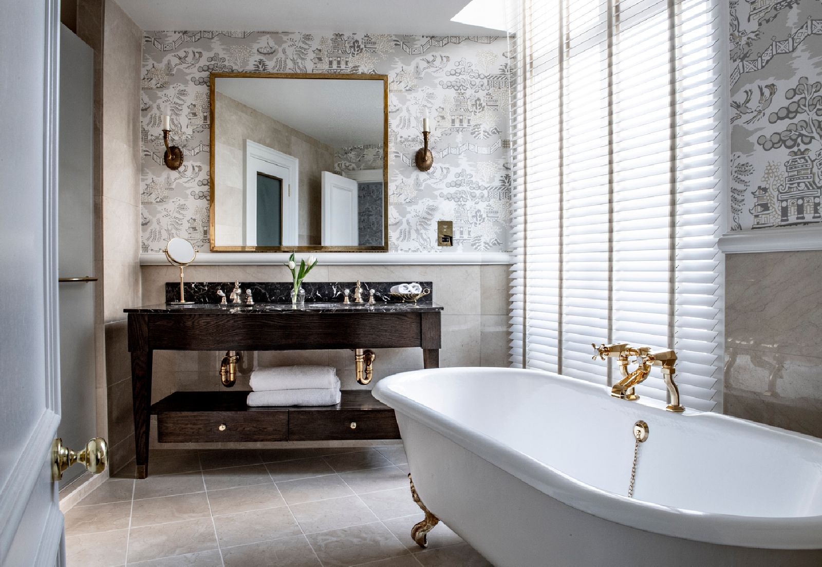 Freestanding tub in the bathroom of a suite at The Kensington hotel in London