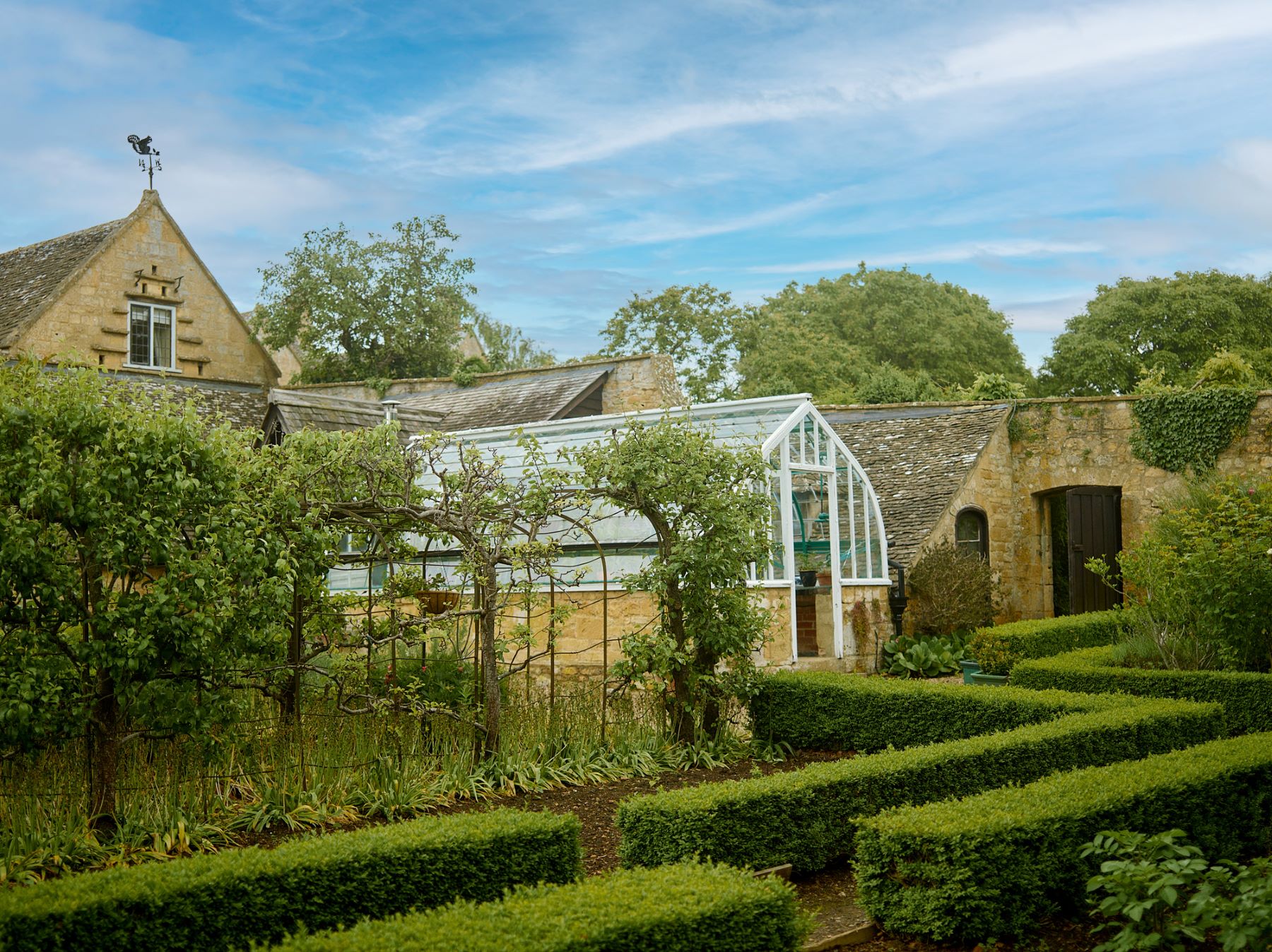 View of the greenhouse in the gardens of Broadway House in the Cotswolds