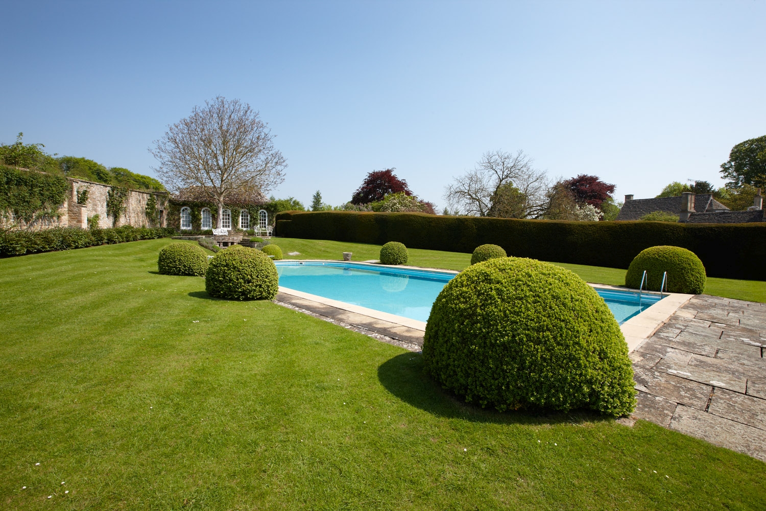 Swimming pool at Living room with fireplace in Cornwell Manor, Cotswolds