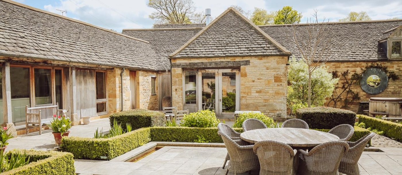 Terrace seating area in the courtyard of Temple Guiting Manor Barn in the Cotswolds, England