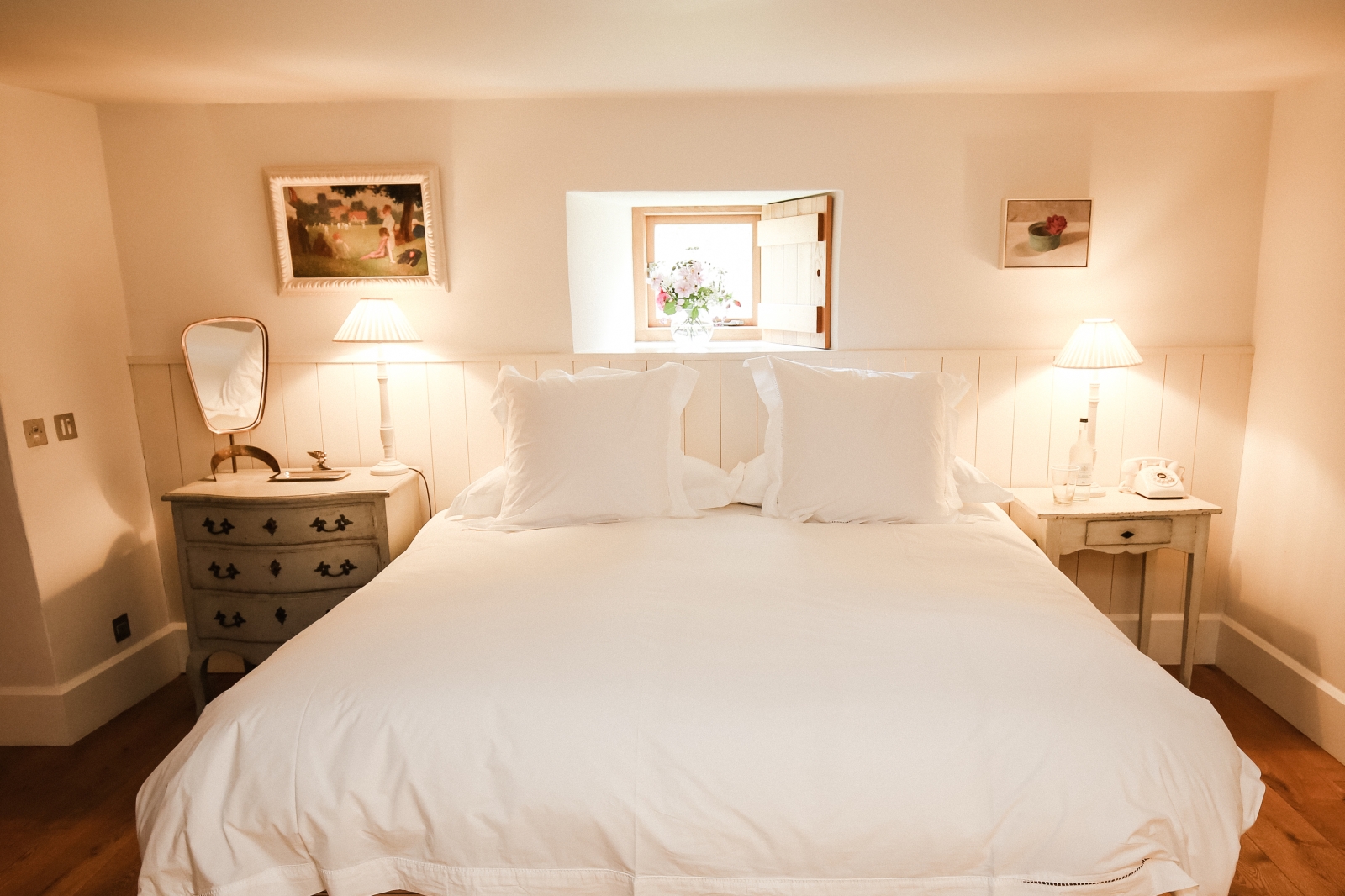 Bedroom with double bed, beside tables, lamps, window and pictures at The Estate at Temple Guiting in the Cotswolds, England