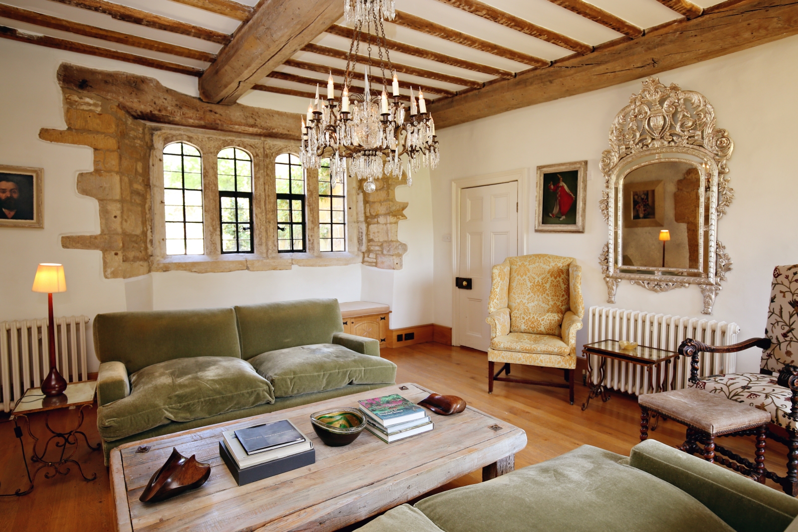 Sitting room with sofas, tables, armchairs, mirror & chandelier at The Estate at Temple Guiting in the Cotswolds, England