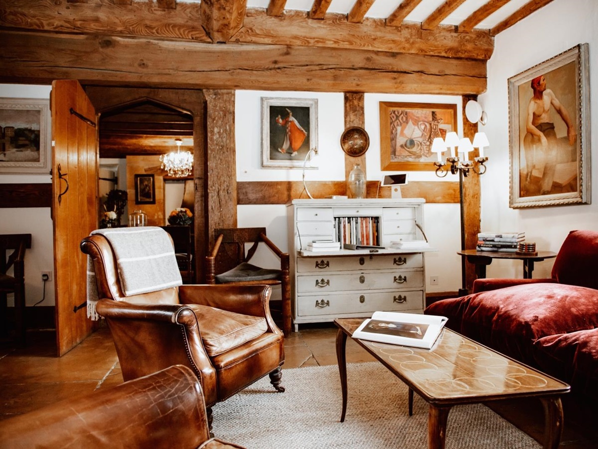 Comfortable rustiv sitting room with leather armchairs at Temple Guiting Manor, luxury villa in the Cotswolds, England
