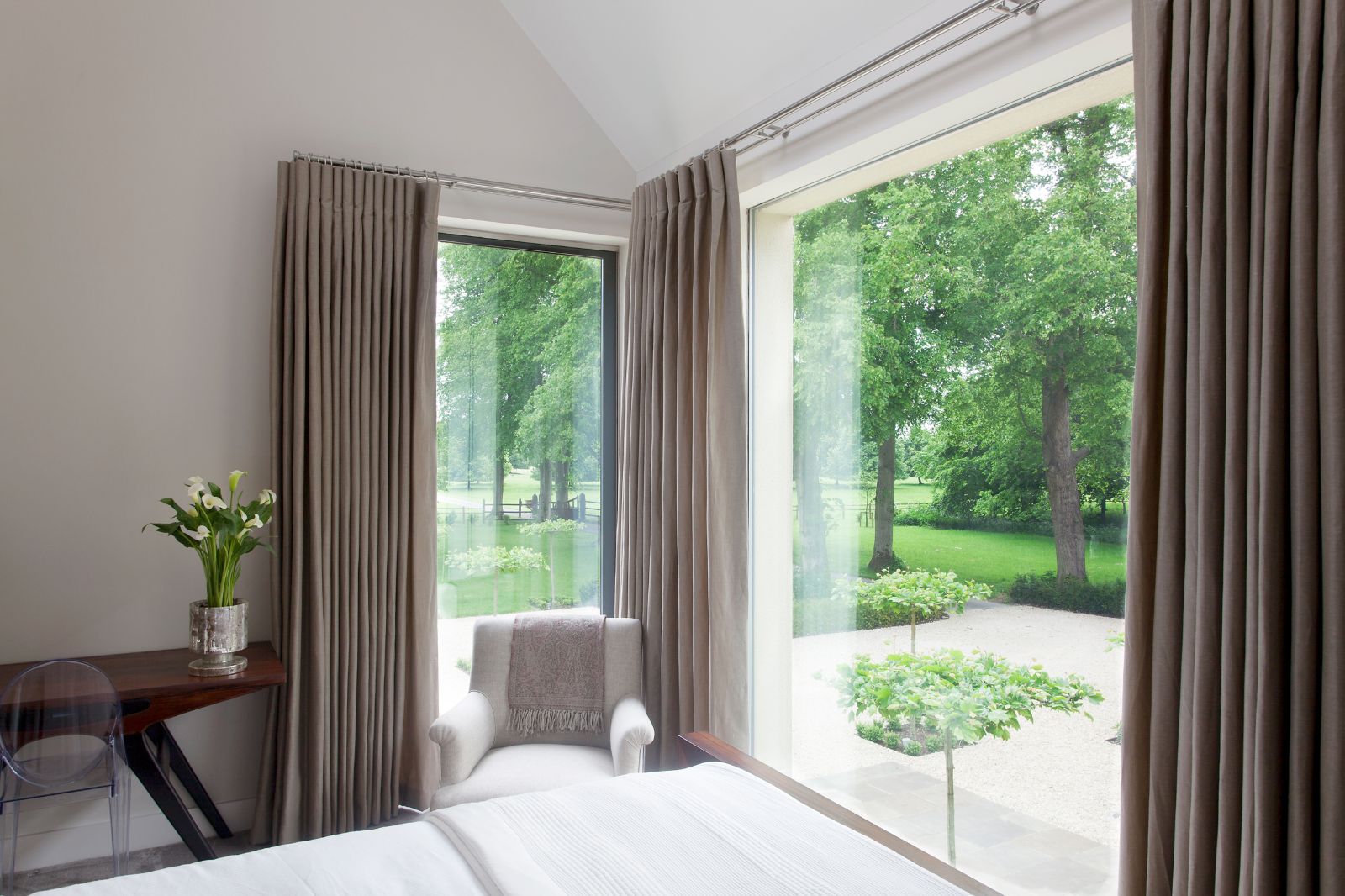 Bedroom with view of garden at Woodstock Lodge