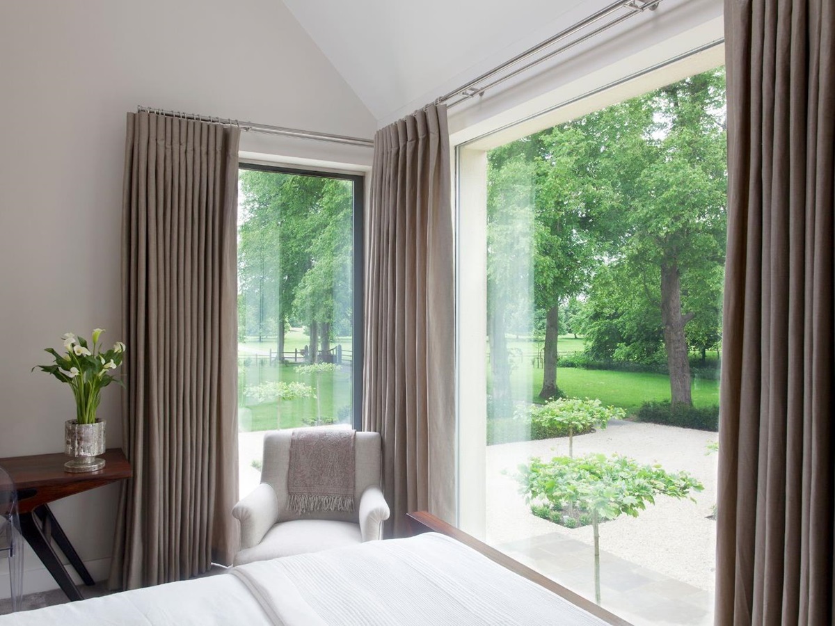 Bedroom with view of garden at Woodstock Lodge