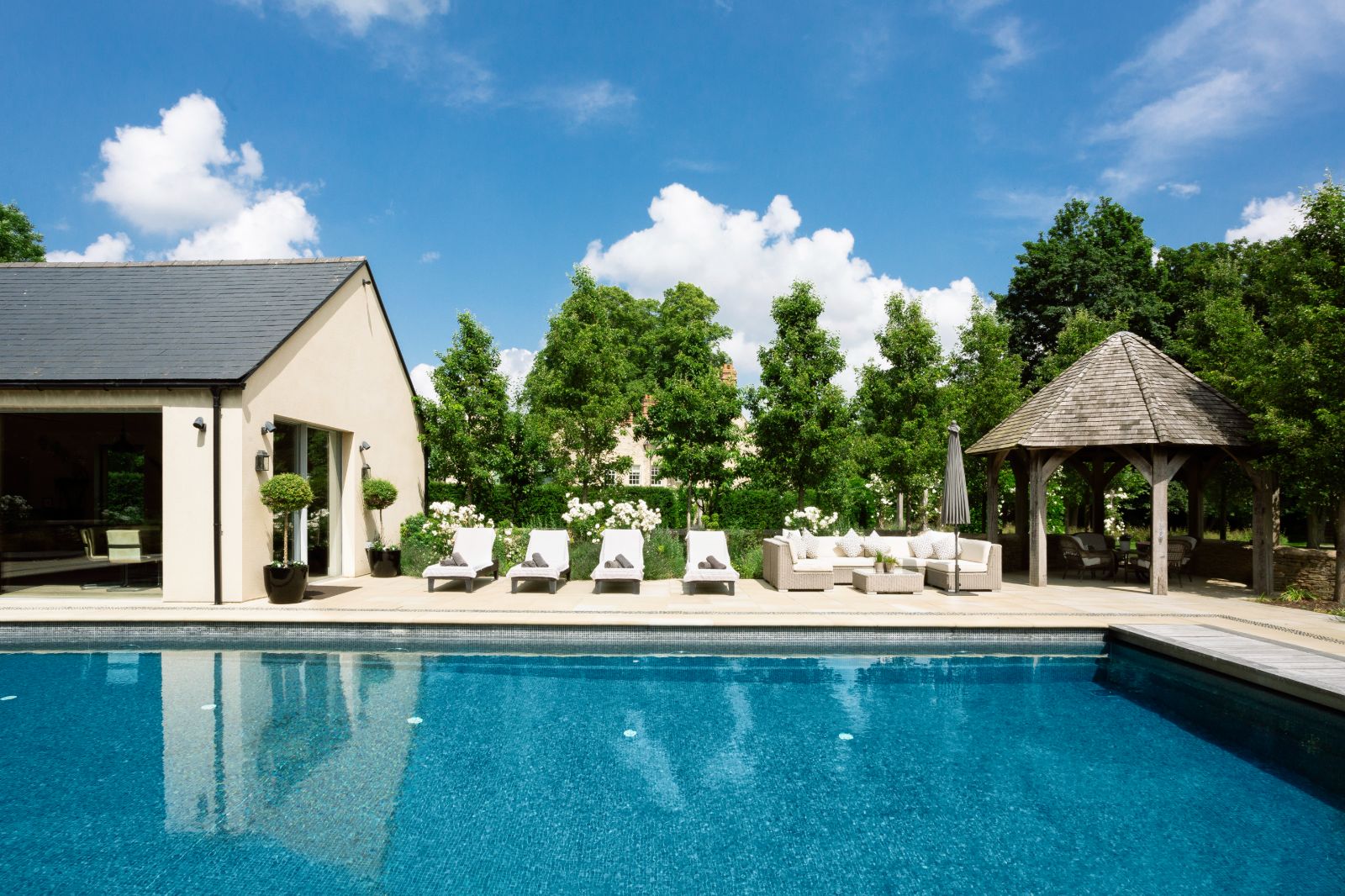 Pool with loungers at Woodstock Lodge