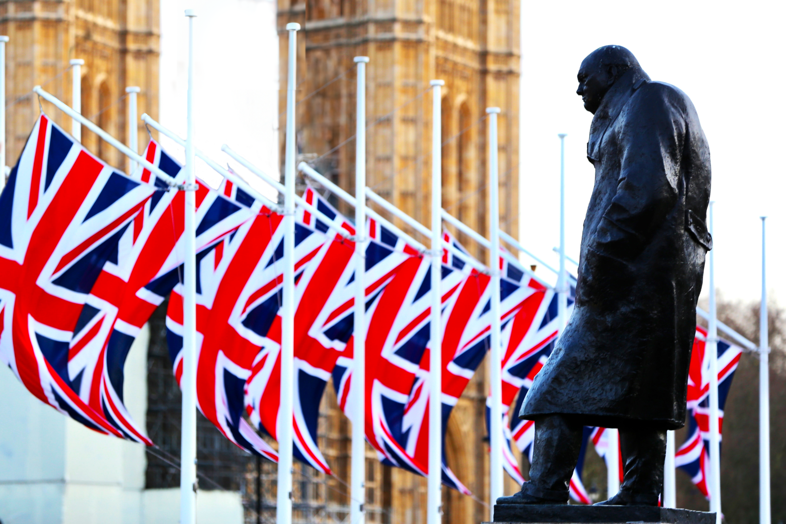 Statue of Winston Churchill amongst flags in London