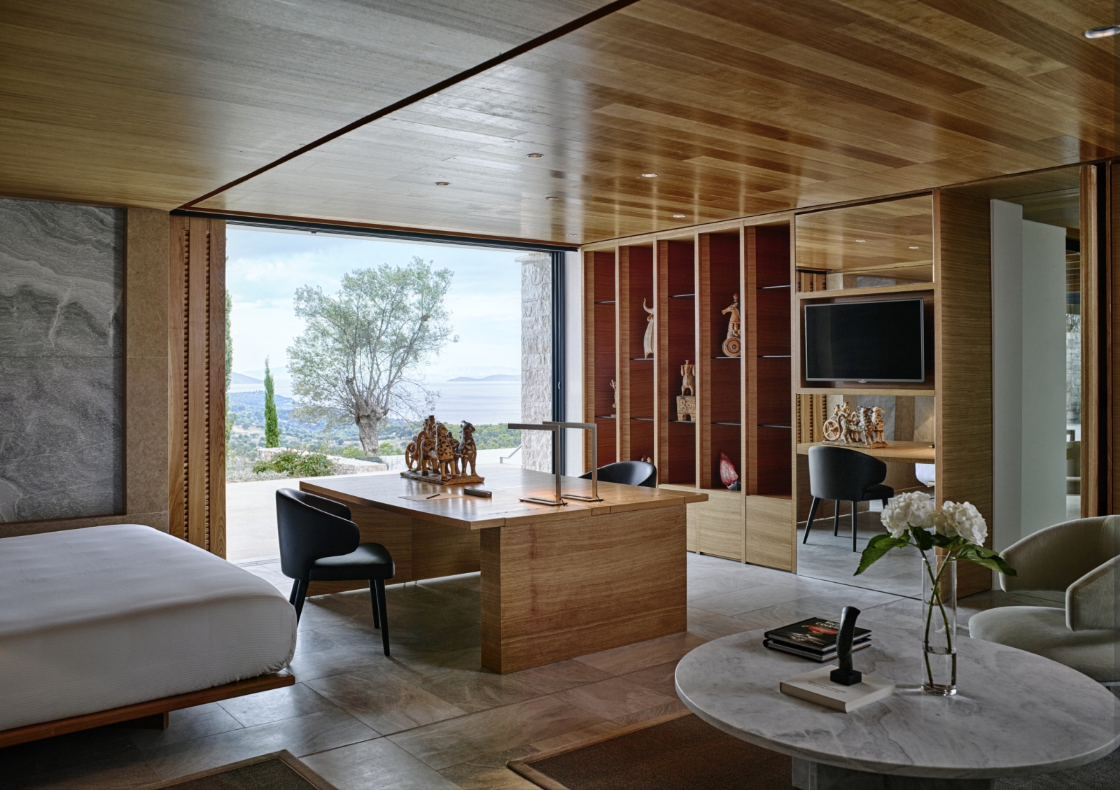 Bedroom at Amanzoe with flat screen and working area