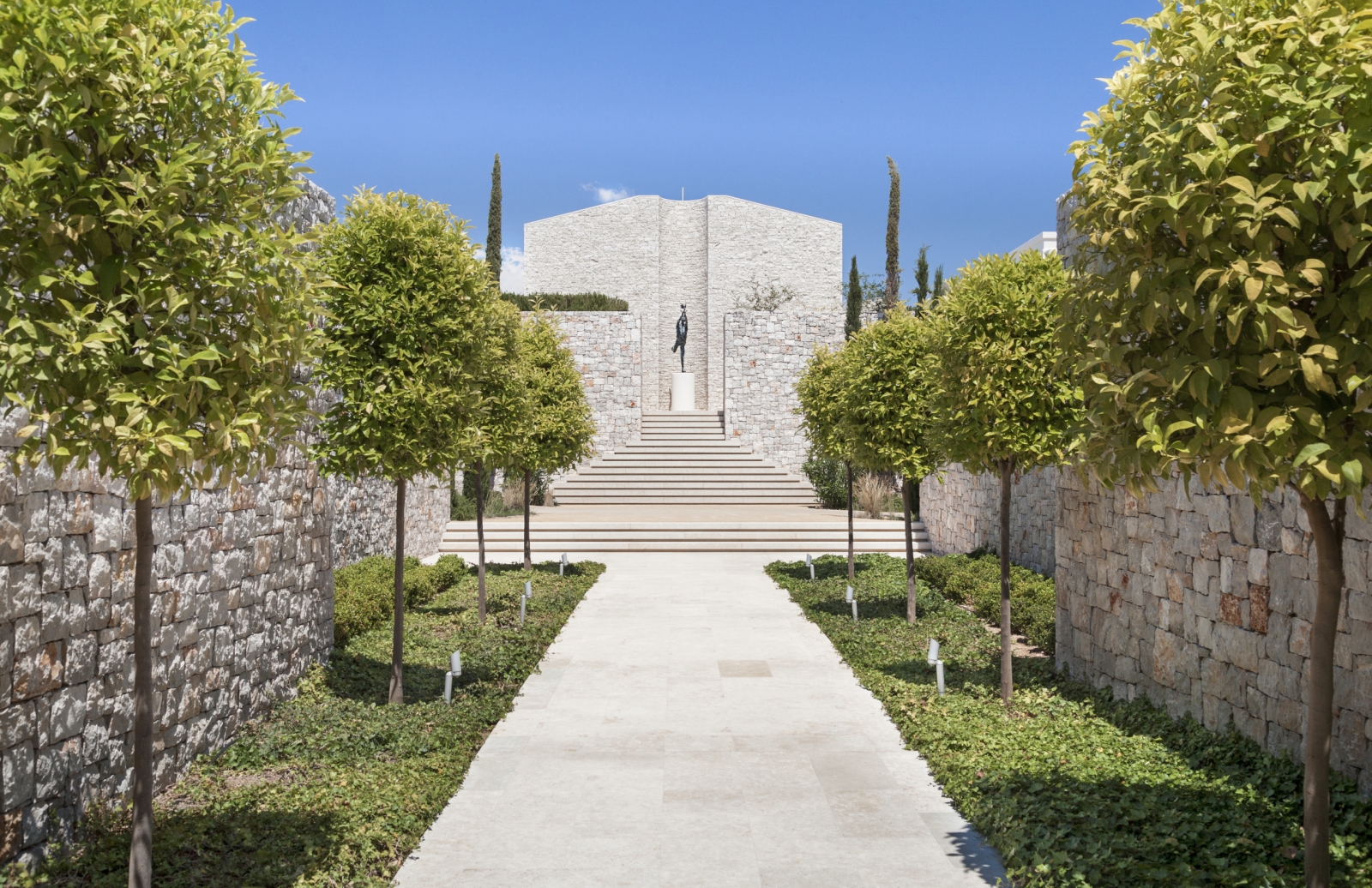 Walkway through the sculptured gardens at Amanzoe