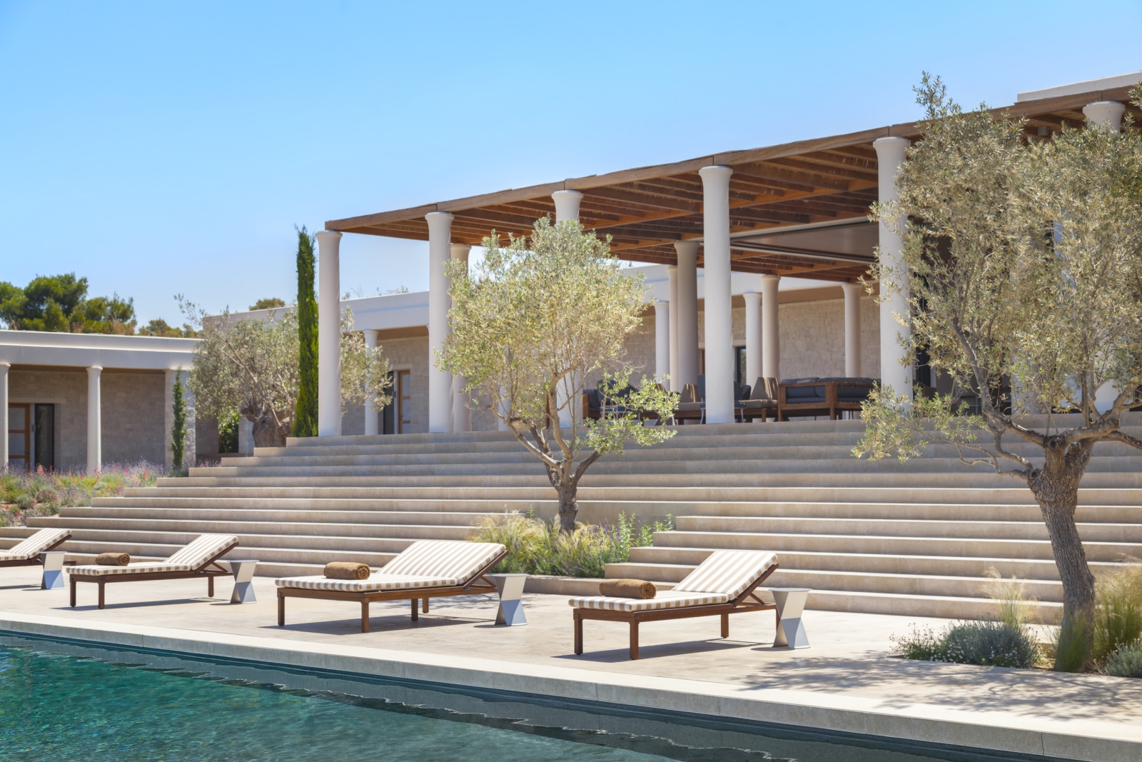 Private pool and loungers in front of villa at Amanzoe