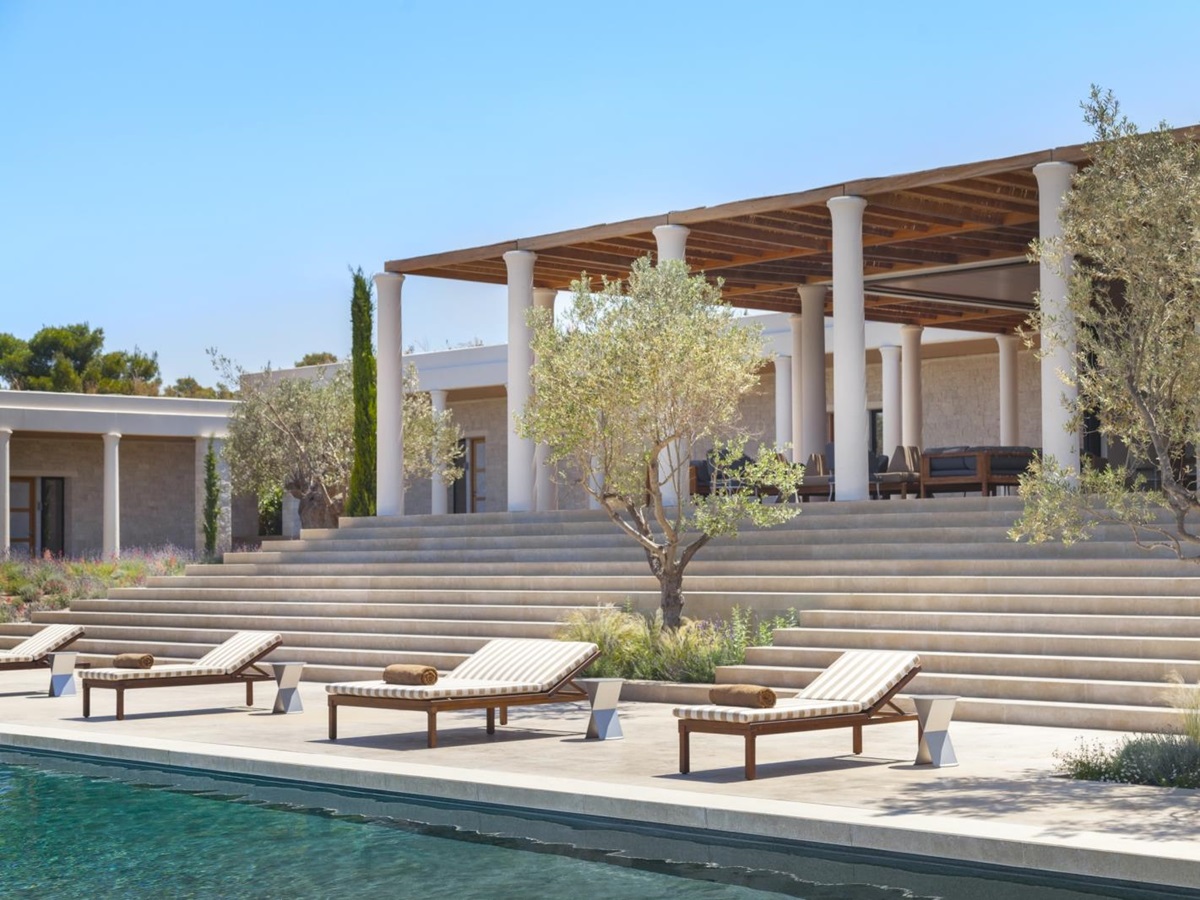 Private pool and loungers in front of villa at Amanzoe