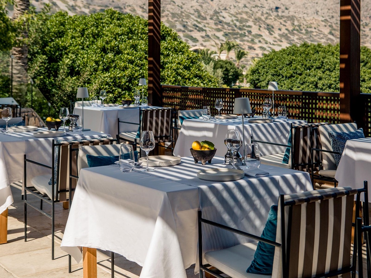 Dining tables at Anthos Restaurant at Phāea Blue Palace in Crete