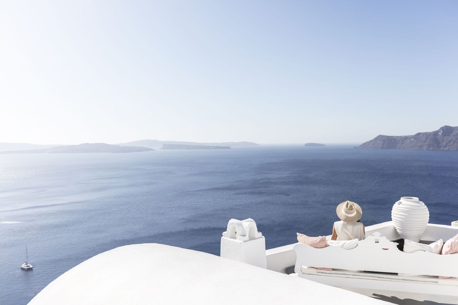 Guest enjoying panoramic Santorini sea views at Canaves Oia Suites in Greece