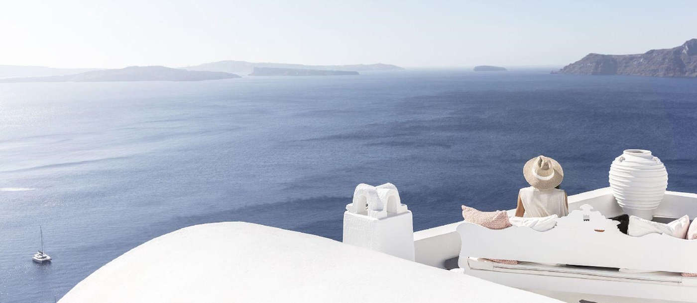 Guest enjoying panoramic Santorini sea views at Canaves Oia Suites in Greece