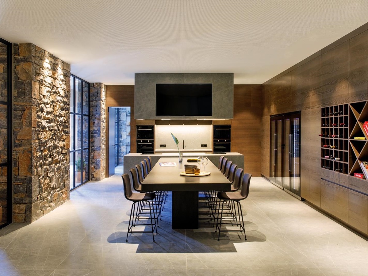 Dining table and show kitchen in the private Culinary School at luxury resort Daios Cove in Greece